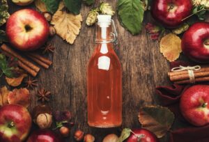 Apple cider vinegar. Bottle of fresh apple organic vinegar on wooden table